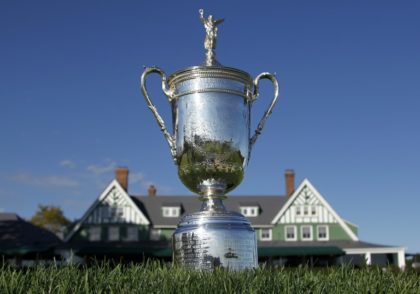 The US Open Championship Trophy is displayed in front of the clubhouse at Oakmont Country