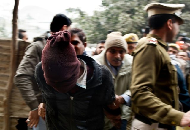 Indian policemen escort a suspect (L) in the gang-rape of a Danish tourist, at the Tis Haz