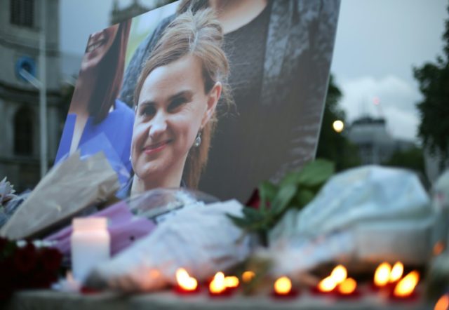 Floral tributes and candles are placed by a picture of murdered Labour MP Jo Cox at a vigi