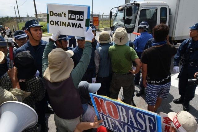 Policemen try to control protesters outside the US Marine Corps' Camp Schwab base in Nago