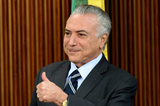 Brazilian acting President Michel Temer gives the thumbs up during a meeting with party le