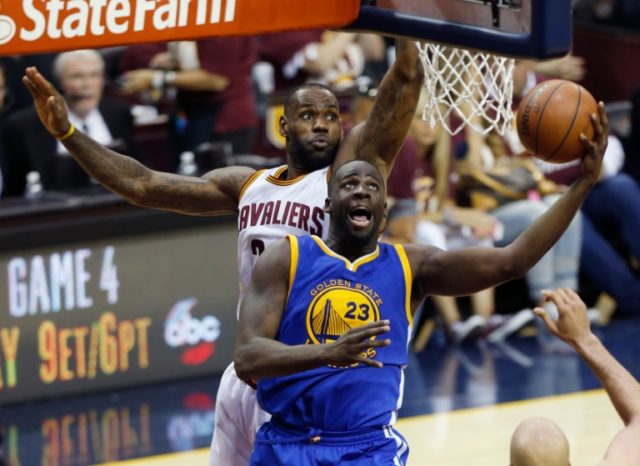 Golden State Warriors forward Draymond Green (R) shoots the ball in front of Cleveland Cavaliers forward LeBron James (L) during Game 3 of the NBA Finals in Cleveland, Ohio on June 8, 2016