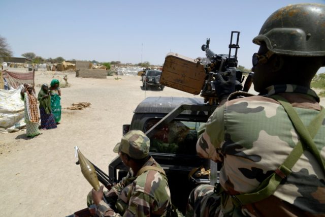 Nigerien soldiers patroling on a road between Diffa and Bosso on May 25, 2015