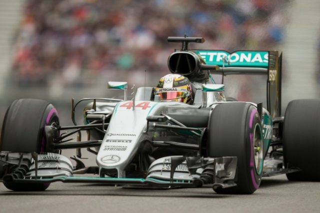 British racing driver Lewis Hamilton of Mercedes accelerates up the hill after turn 2 on t