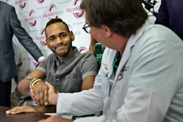 Angel Colon (L), a surviver of the Pulse nightclub mass shooting, shakes the hand of Dr. S