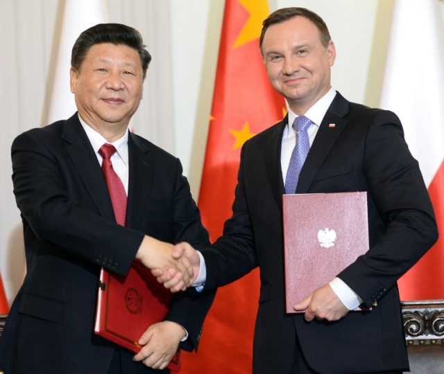 Xi Jinping and Andrzej Duda shake hands after signing a cooperation treaty in Warsaw on Ju
