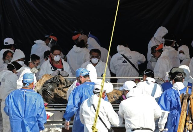Forensic medical personnel recover a corpse from a mass grave in Tetelcingo, Morelos, Mexi