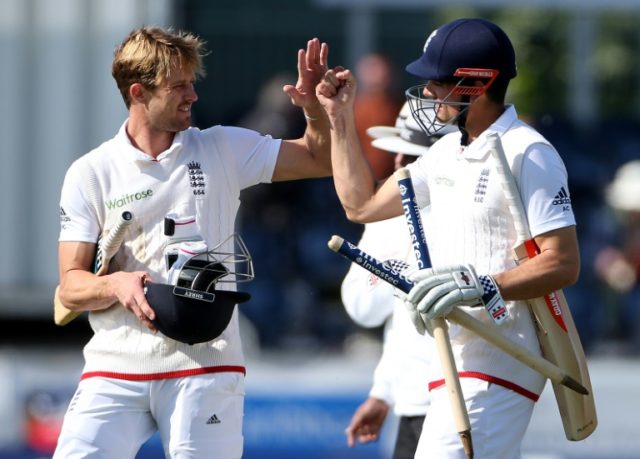 England's captain Alastair Cook, right and England's Nick Compton celebrate after England
