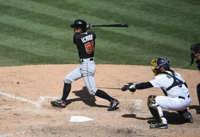 Ichiro Suzuki of the Miami Marlins hits a double during the ninth inning against the San D