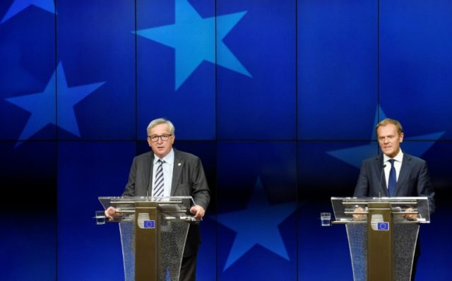 EU Commission President Jean-Claude Juncker (L) gives a press conference with EU Council P