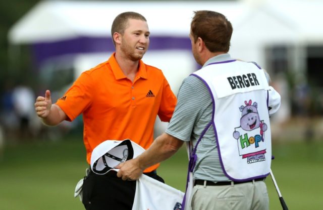 Daniel Berger (L) of the US celebrates with his caddie after winning the FedEx St. Jude Cl