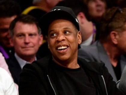 Jay-Z smiles as he sits courtside as the Los Angeles Lakers take on the Utah Jazz at Stapl