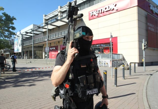 A policeman stands near a cinema where an armed man barricaded himself in Viernheim, south