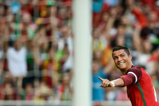 Portugal's forward Cristiano Ronaldo celebrates after scoring against Estonia during the f