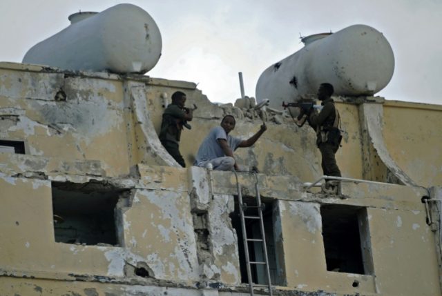 Somali security forces clear the upper floor of the Ambassador Hotel in Mogadishu, the sce