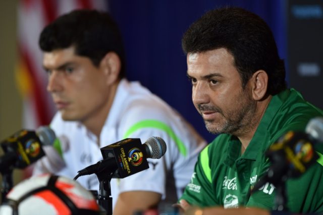 Bolivia coach Julio Cesar Baldivieso (R) and player Carlos Lampe speak to the press ahead