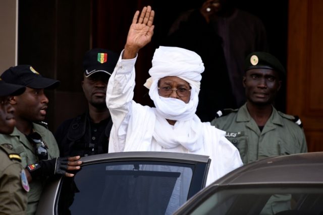 Former Chadian dictator Hissene Habre gestures as he leaves a Dakar courthouse after an id