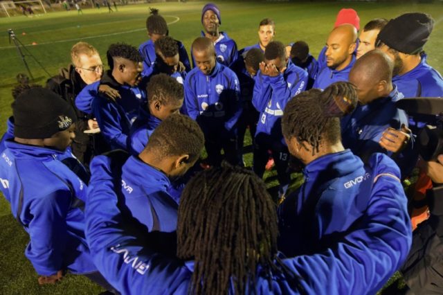 Players of Hungarian Internationale CDF football team pray after their training session at