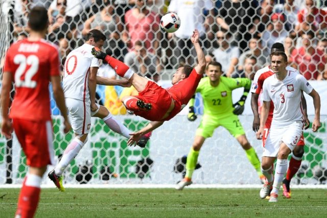 Switzerland midfielder Xherdan Shaqiri (C) scores his team's equaliser during the Euro 201