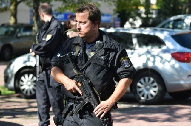 Armed police stand guard outside the cinema in Viernheim, southern Germany, on June 23, 20