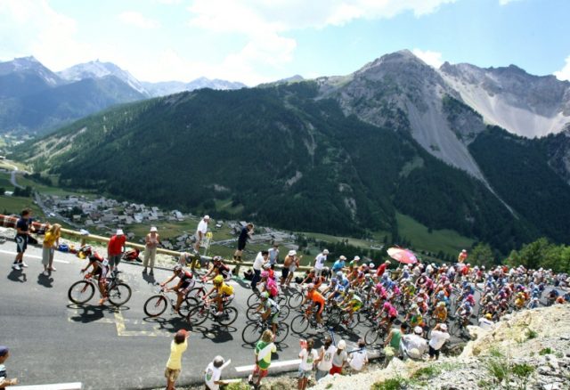 Cyclists taking part in the Tour de France ride up a mountain in the Alps