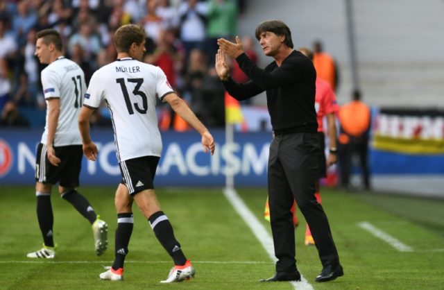 Germany's coach Joachim Loew (R) gives instructions to Germany's midfielder Thomas Mueller