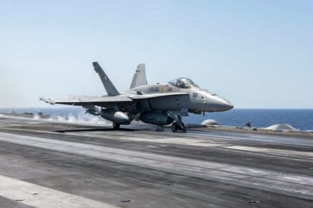 US Navy photo shows an F/A-18C Hornet launching from the flight deck of the USS Harry S.