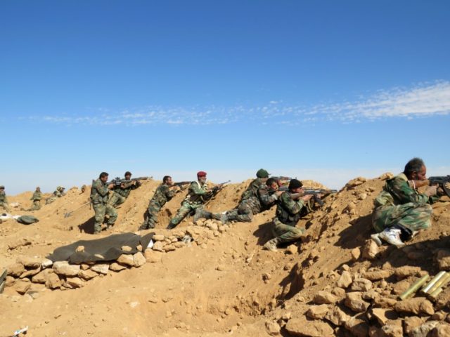 Syrian army soldiers take positions on the outskirts of Syria's Raqa region on February 19