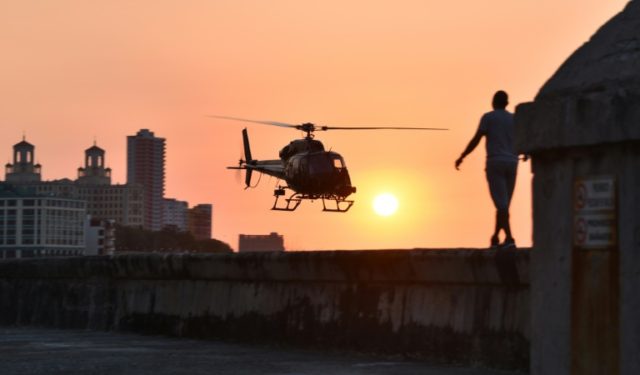Cubans look at one of the helicopters from Universal Studios used during the shooting of "