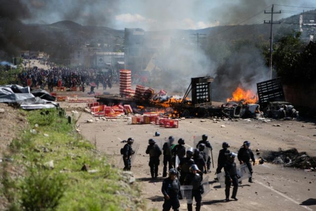 Members of the Mexican Federal Police clash with teachers holding a protest against educa