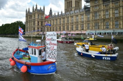 A Brexit flotilla of fishing boats passes the Houses of Parliament as it sails up the rive