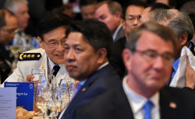 China's Admiral Sun Jianguo (L background), deputy chief of general staff of the PLA, and
