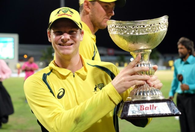 Australian cricket team captain Steven Smith poses with their winning trophy at the end of