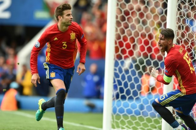 Spain defender Gerard Pique (L) celebrates with teammate Sergio Ramos after scoring the op