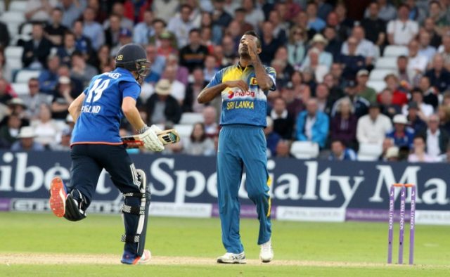 Sri Lanka's Farveez Maharoof (R) reacts as Chris Woakes takes a single to reach 50 during