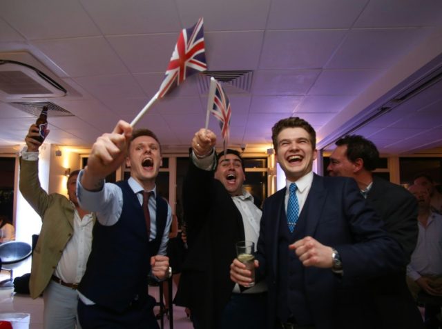 Leave.EU supporters wave Union flags and cheer as the results come in at the Leave.EU refe