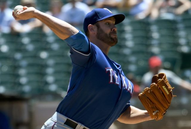Colby Lewis #48 of the Texas Rangers pitches against the Oakland Athletics in the bottom o