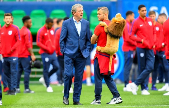 England's head coach Roy Hodgson (L) speaks to midfielder Jack Wilshere while they check a
