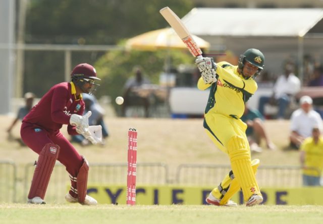 Australian cricketer Usman Khawaja (R) plays a shot on June 13, 2016