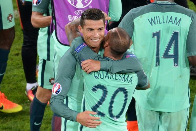 Portugal's Cristiano Ronaldo (L) celebrates with teammate Ricardo Quaresma at the end of t