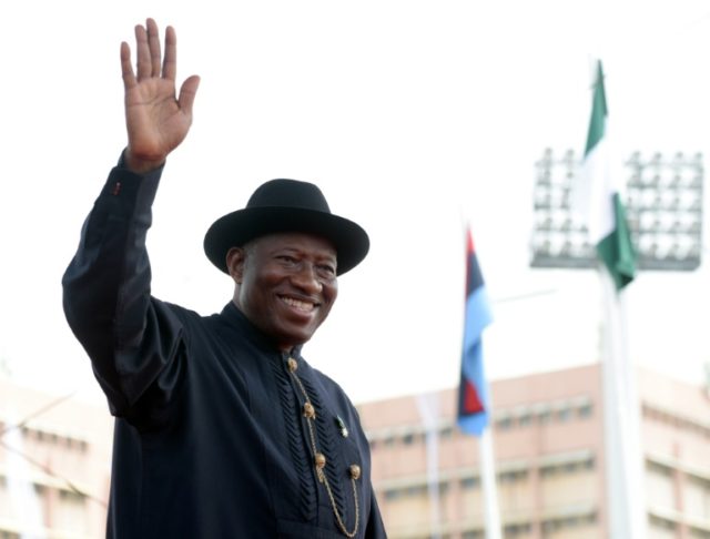 Former President Goodluck Jonathan waves to the crowd as he leaves the office during the i
