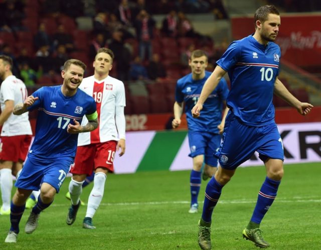 Iceland's Gylfi Sigurdsson (R) and Aron Gunnarsson (L) celebrate a goal during the interna