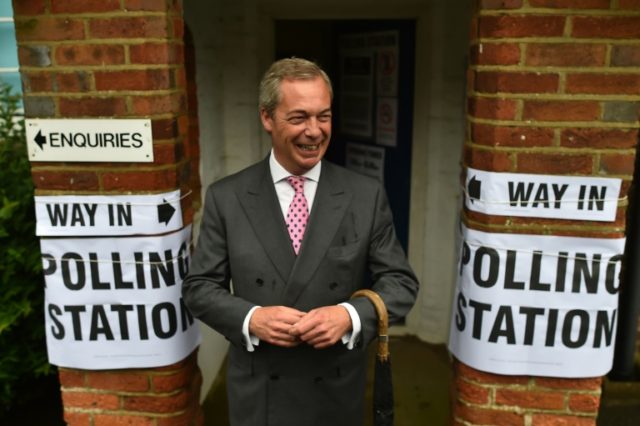 UK Independence Party (UKIP) leader Nigel Farage poses for photographers as he leaves a po