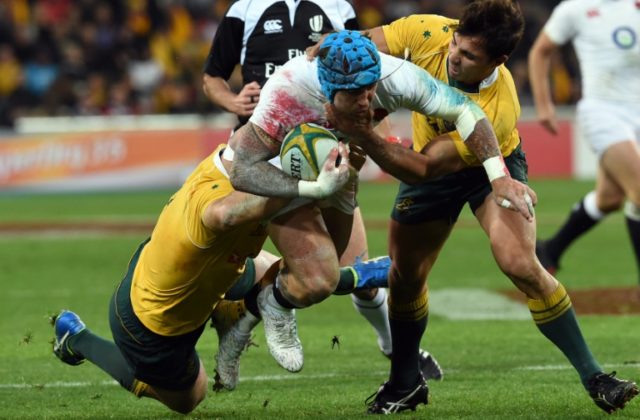 England's Jack Nowell (centre) is tackled by Australia's Sekope Kepu (right) and Stephen M