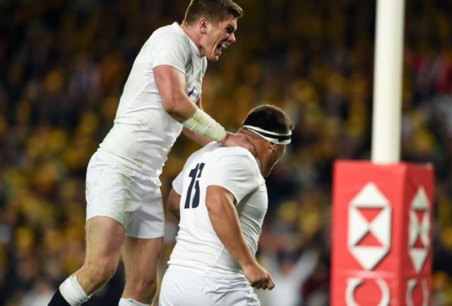 England's Owen Farrell (L) celebrates a successful try against Australia with teammate Jam