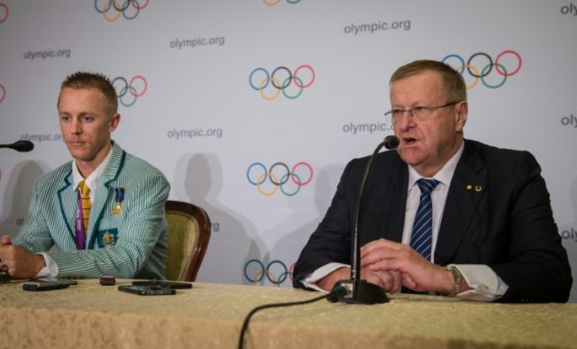 Australian athlete Jared Tallent listens as International Olympic Committee vice-president