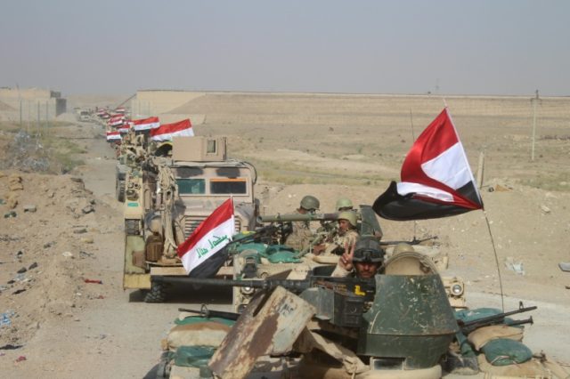 Iraqi government forces are seen near the Falahat village west of Fallujah on June 27, 201