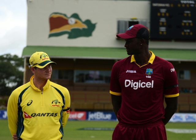Australia's Captain Steven Smith (L) and The West Indie's Captain Jason Holder look on bef