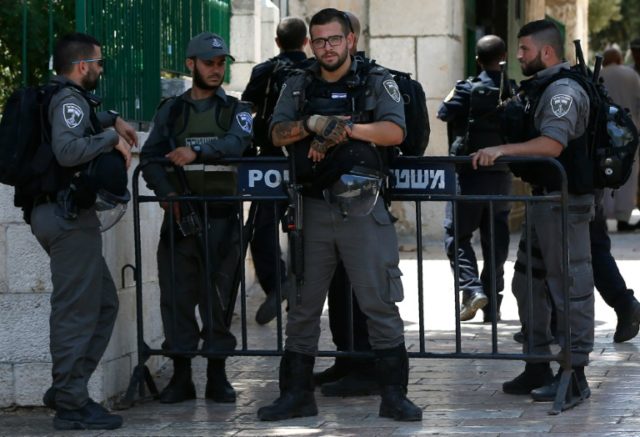 Israeli security forces stand guard at the entrance of the Al-Aqsa mosque compound in Jeru