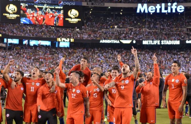 Chile's players celebrate after defeating Argentina in the penalty shoot-out and winning t